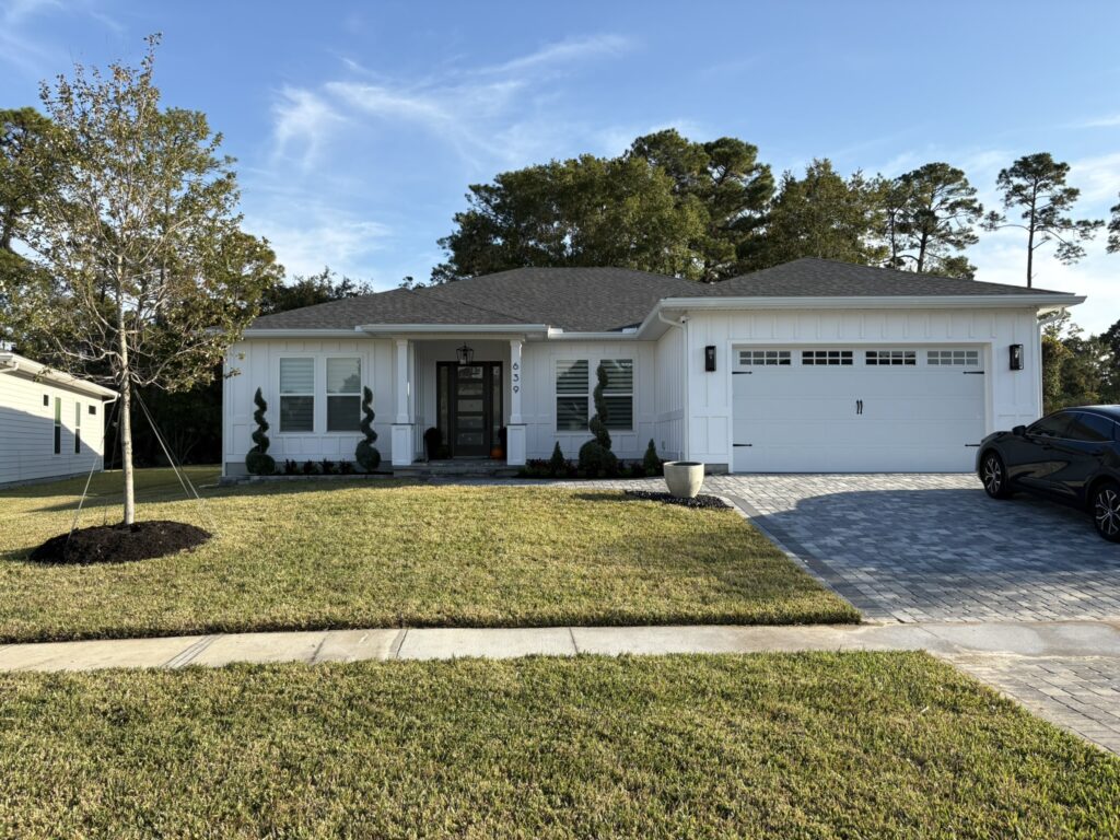 St. Augustine home landscape design with spiral topiary and foundation plantings