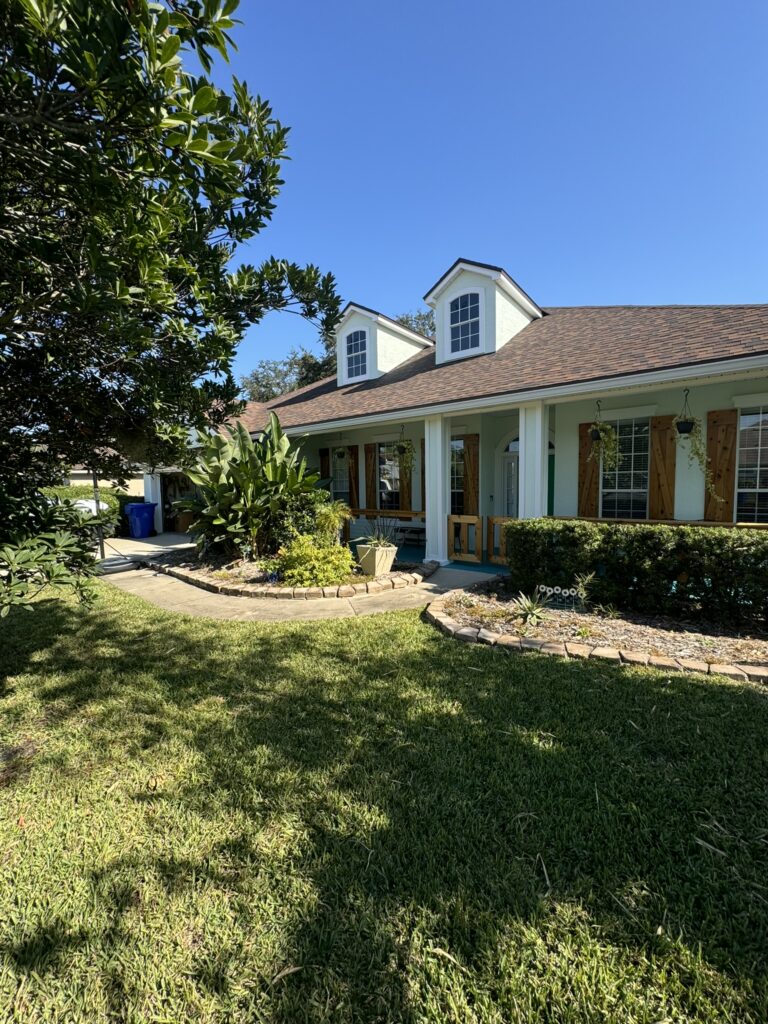 Residential landscape design with curved walkway bed and foundation plantings
